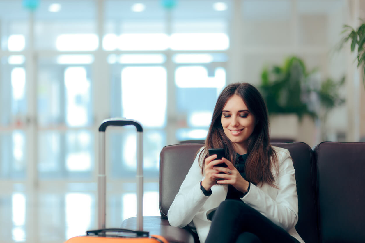 girl buying e-ticket, making hotel reservations and checking in online